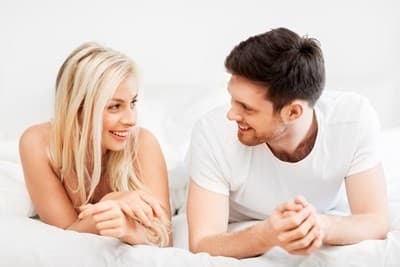happy-couple-on-bed